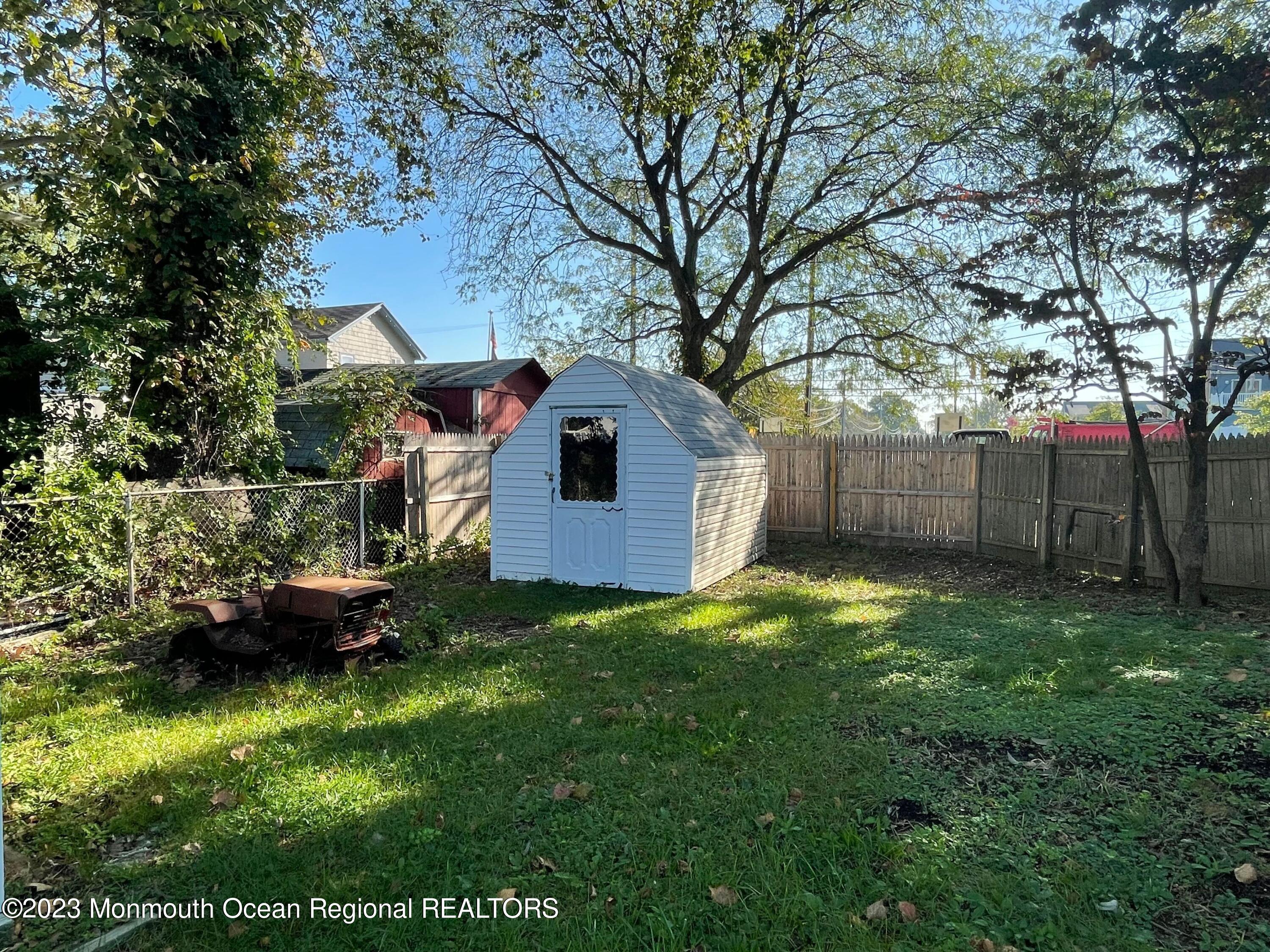 509 Stone Road Union Beach, NJ 07735 - Photo 11 of 12 a backyard of a house with plants and large tree