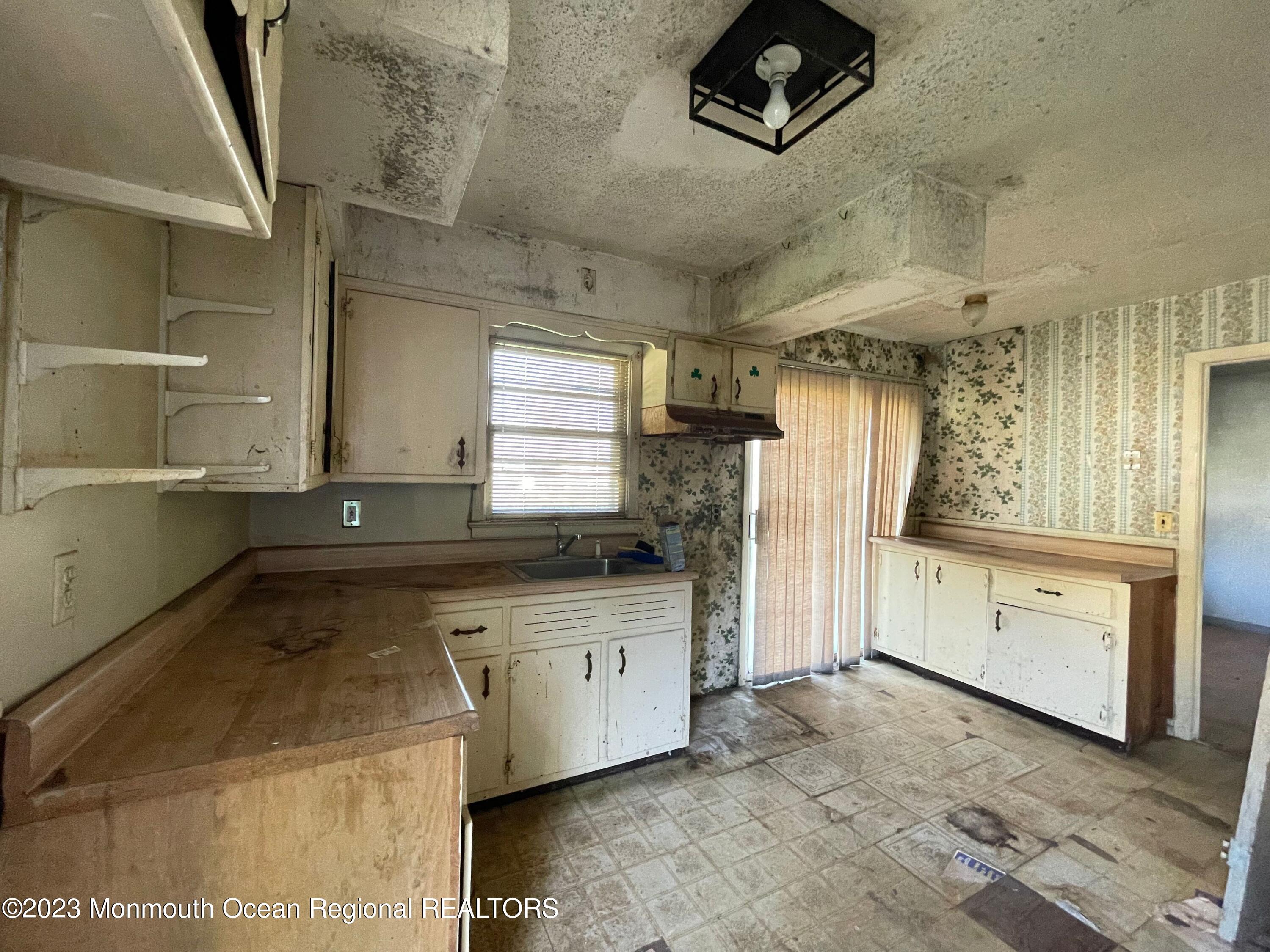 509 Stone Road Union Beach, NJ 07735 - Photo 4 of 12 a kitchen with stainless steel appliances granite countertop a sink a stove and a refrigerator