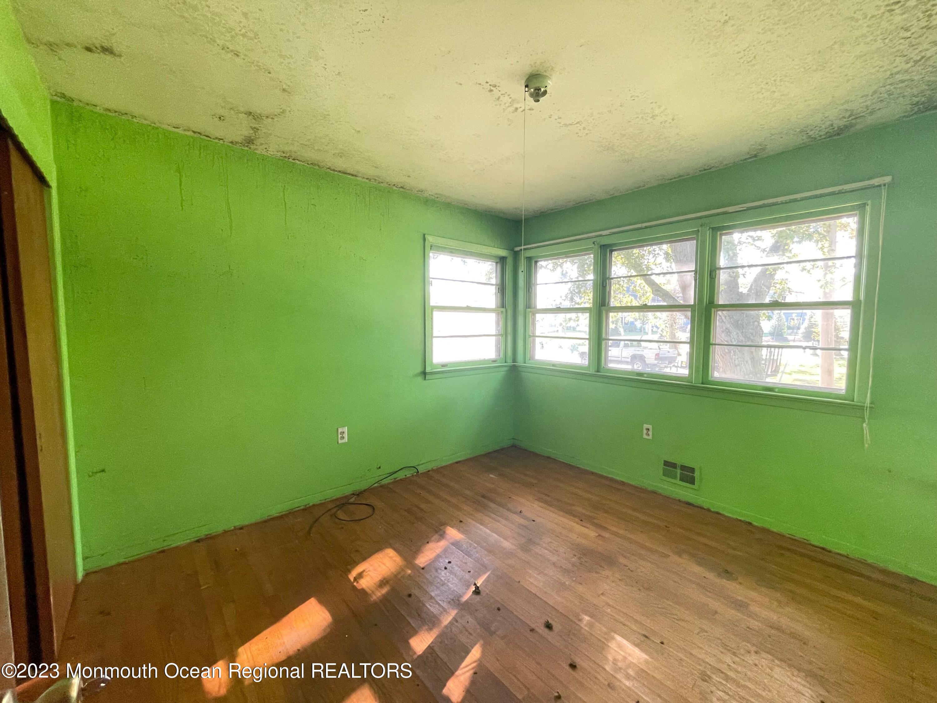 509 Stone Road Union Beach, NJ 07735 - Photo 6 of 12 a bedroom with a window and a ceiling fan