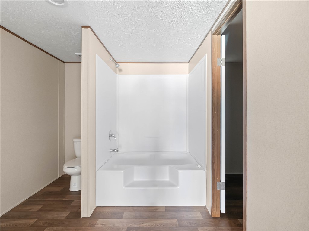 401 Mormon Church Road Seneca, SC 29678 - Photo 23 of 43 This clean bathroom features a shower-tub combo and durable flooring, offering a fresh, functional space.