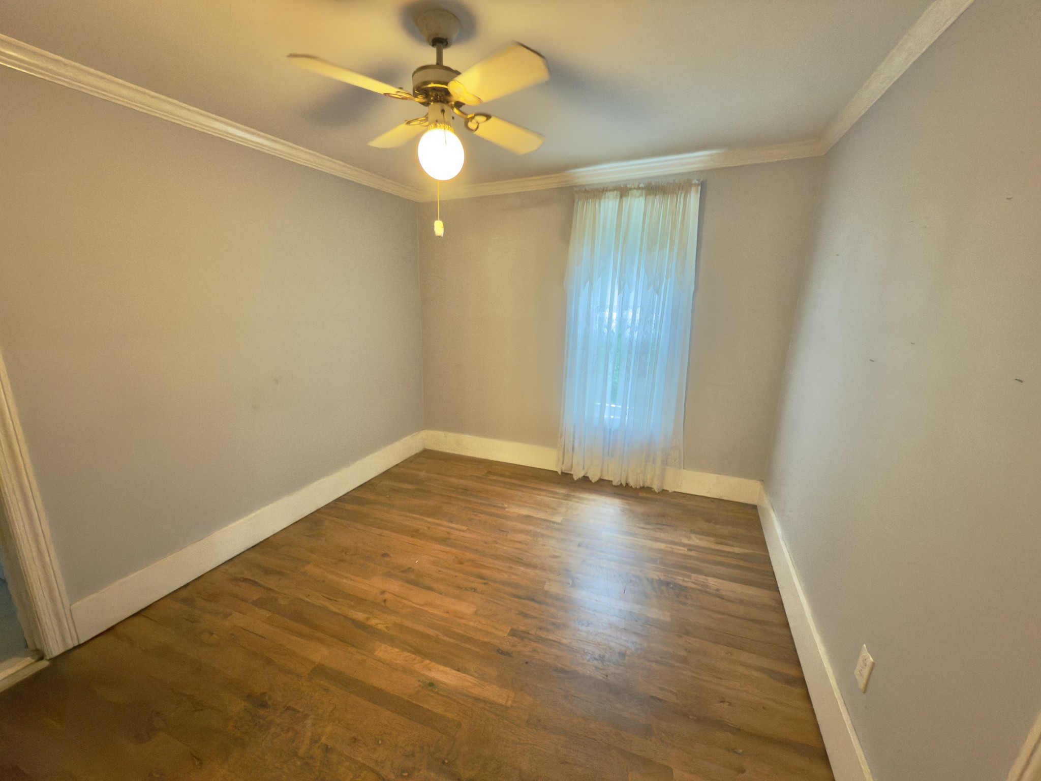546 Womack Hollow Road Liberty, TN 37095 - Photo 32 of 43 an empty room with a chandelier fan and wooden floor
