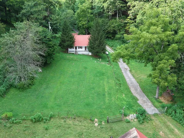 a backyard of a house with table and chairs