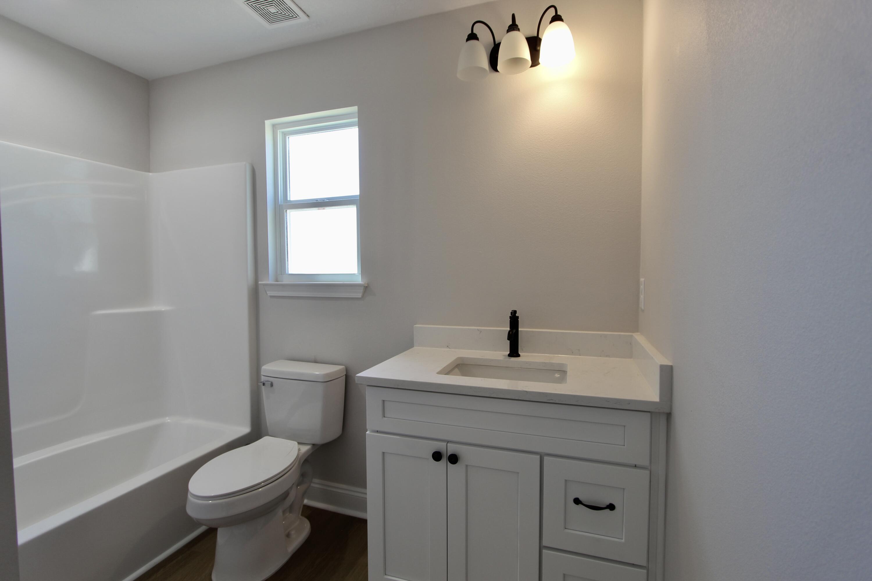 4608 Bobolink Way Crestview, FL 32539 - Photo 12 of 25 a bathroom with a sink toilet tub and vanity