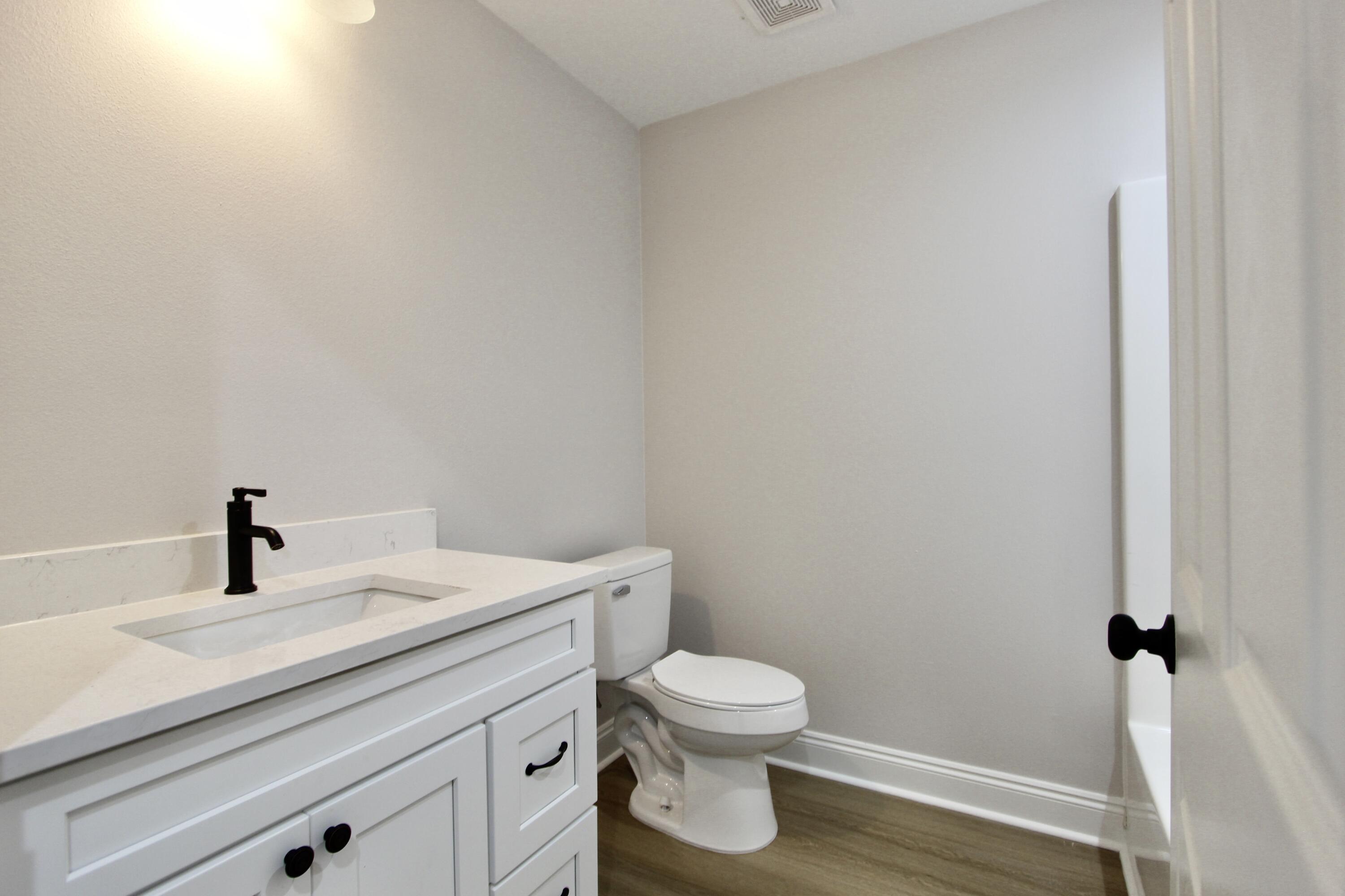 4608 Bobolink Way Crestview, FL 32539 - Photo 15 of 25 a bathroom with a sink a toilet and a mirror