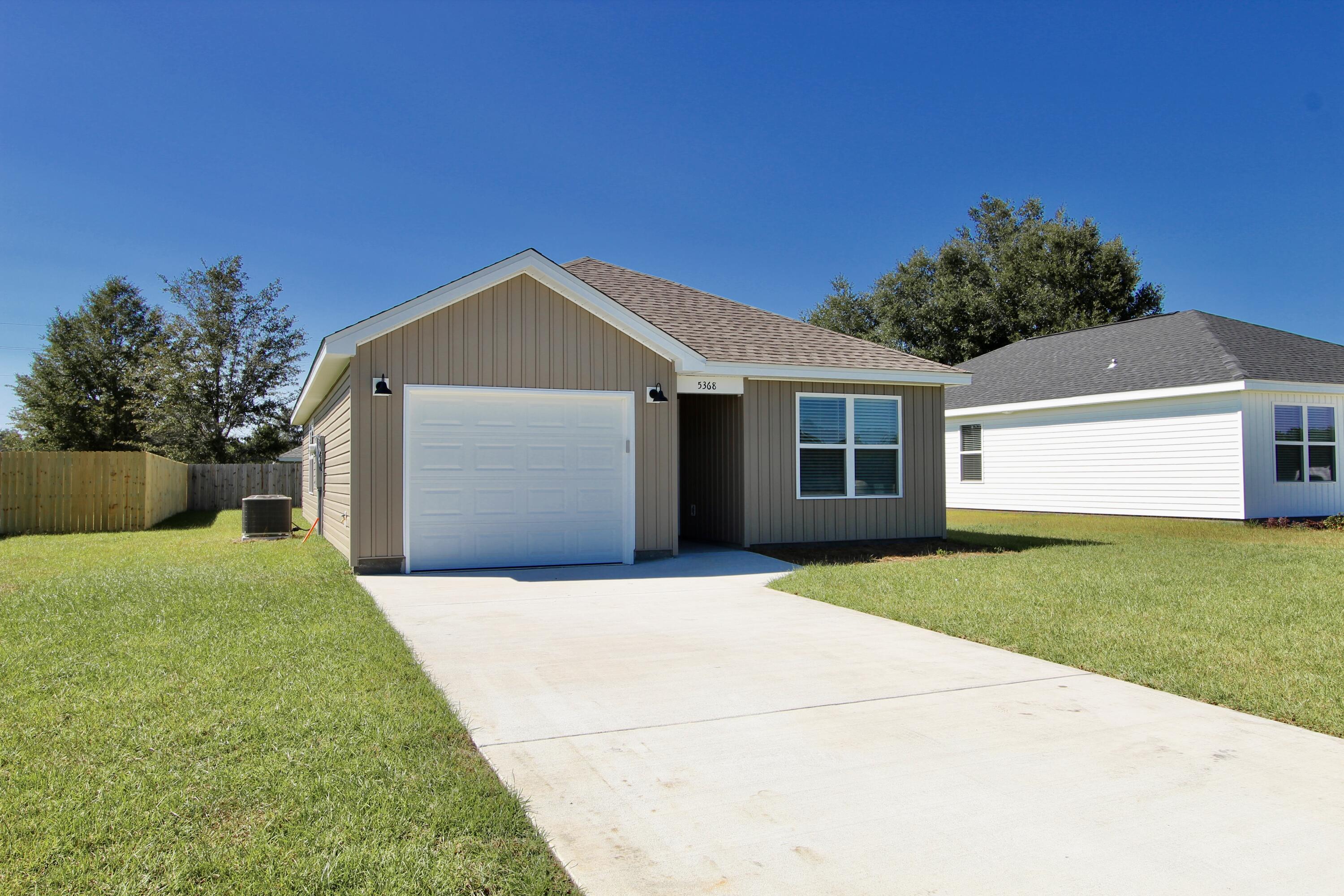 4608 Bobolink Way Crestview, FL 32539 - Photo 3 of 25 a front view of a house with a yard and garage
