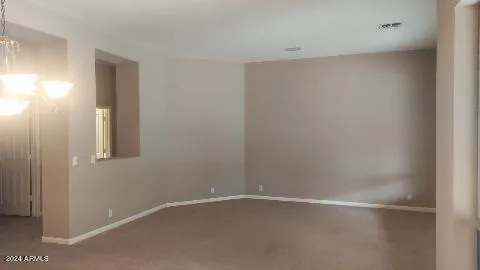 a view of a livingroom with a fireplace and window
