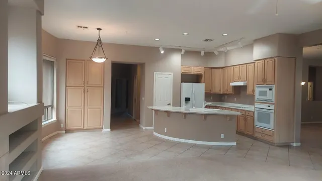 a kitchen with granite countertop white cabinets and sink