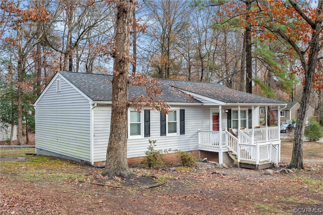 4211 Bridgewood Road Midlothian, VA 23112 - Photo 21 of 27 a front view of a house with a yard tree and wooden fence
