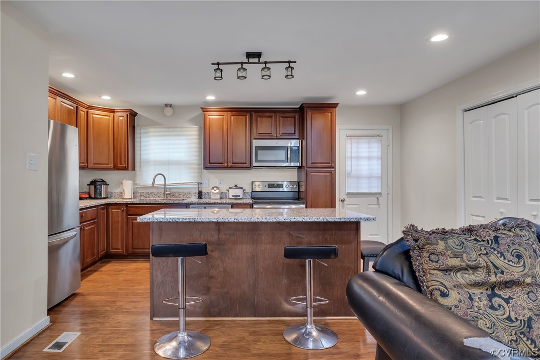 4211 Bridgewood Road Midlothian, VA 23112 - Photo 4 of 27 a kitchen with a sink refrigerator and cabinets