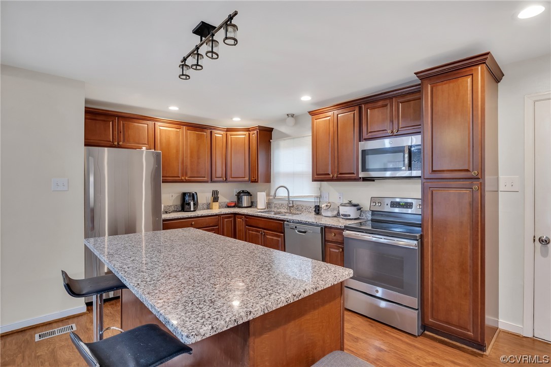 4211 Bridgewood Road Midlothian, VA 23112 - Photo 8 of 27 a kitchen with stainless steel appliances granite countertop a refrigerator a stove top oven a sink dishwasher and wooden cabinets