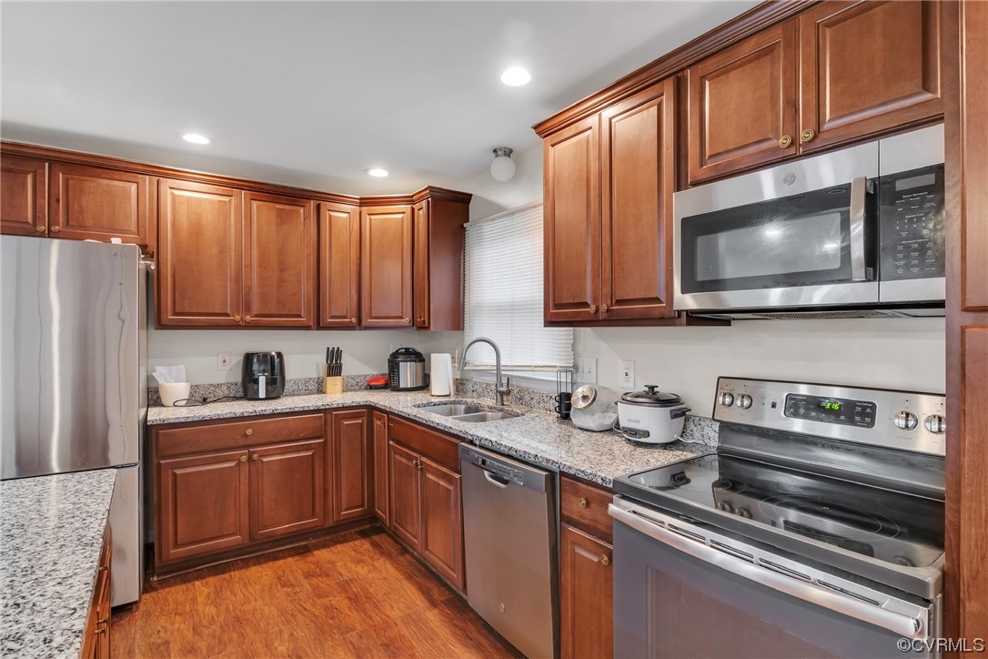 4211 Bridgewood Road Midlothian, VA 23112 - Photo 9 of 27 a kitchen with stainless steel appliances granite countertop wooden cabinets a stove a sink and dishwasher