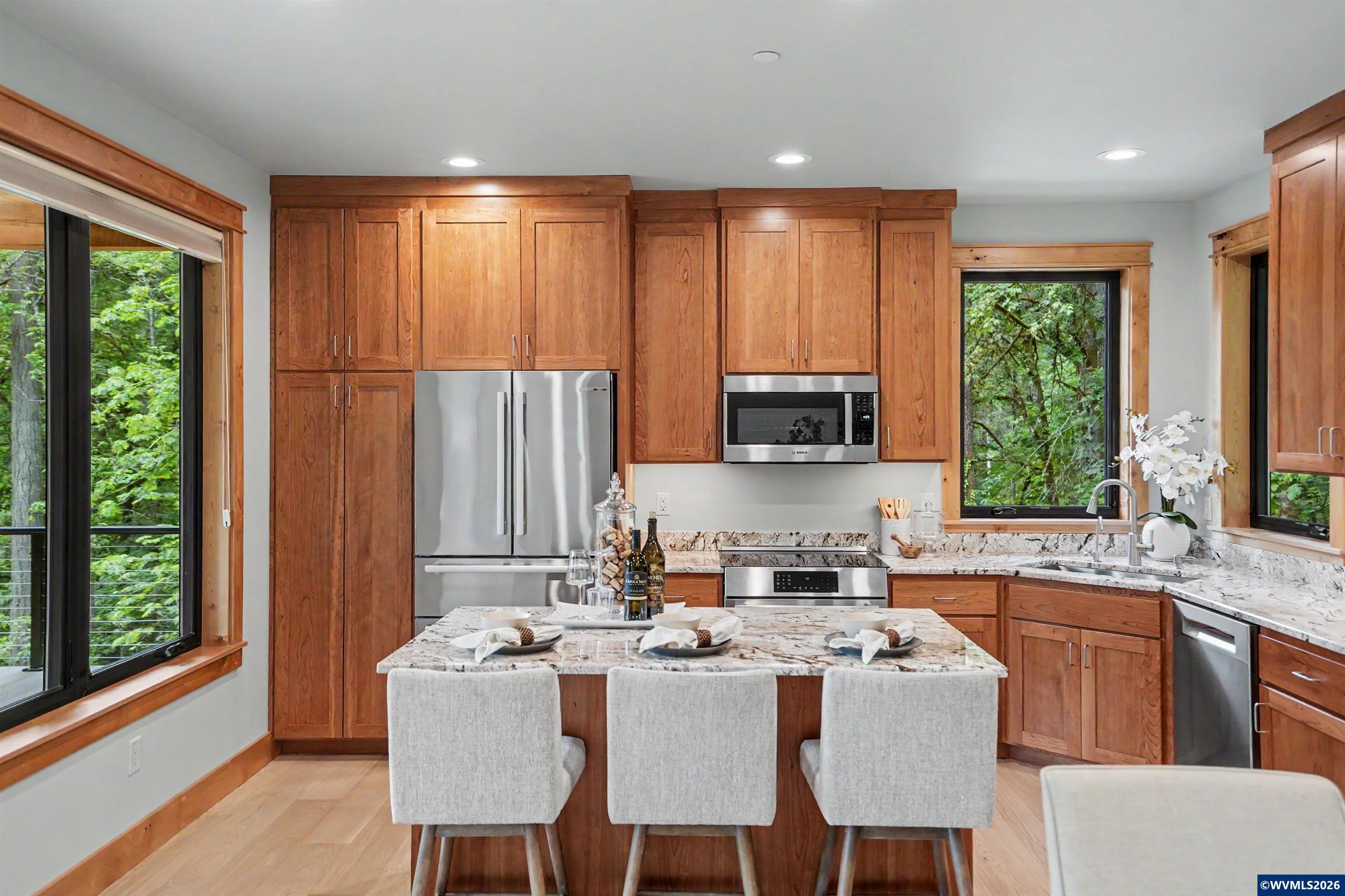 1155 Northwest Country Hills Road Corvallis, OR 97330 - Photo 26 of 48 a kitchen with a table chairs sink and cabinets
