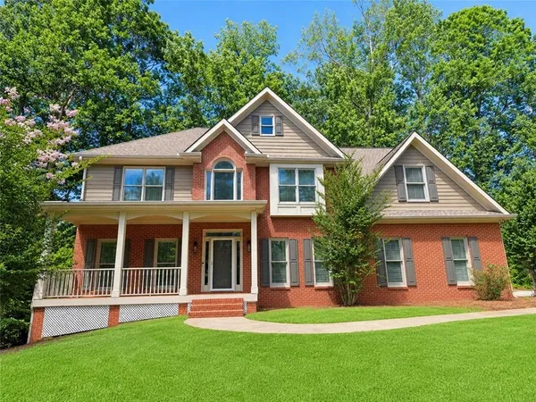 a front view of a house with a yard and garage