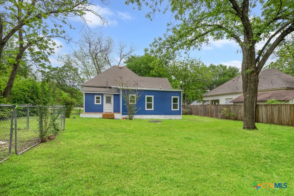 607 West 3rd Street Eddy, TX 76524 - Photo 27 of 29 a front view of a house with garden