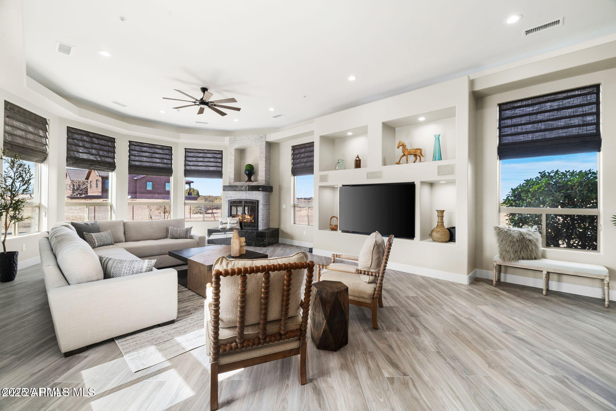 4140 Chuckwalla Road Prescott, AZ 86305 - Photo 21 of 77 a living room with furniture a flat screen tv and a fireplace