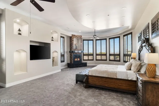 a bedroom with a bed and a chandelier