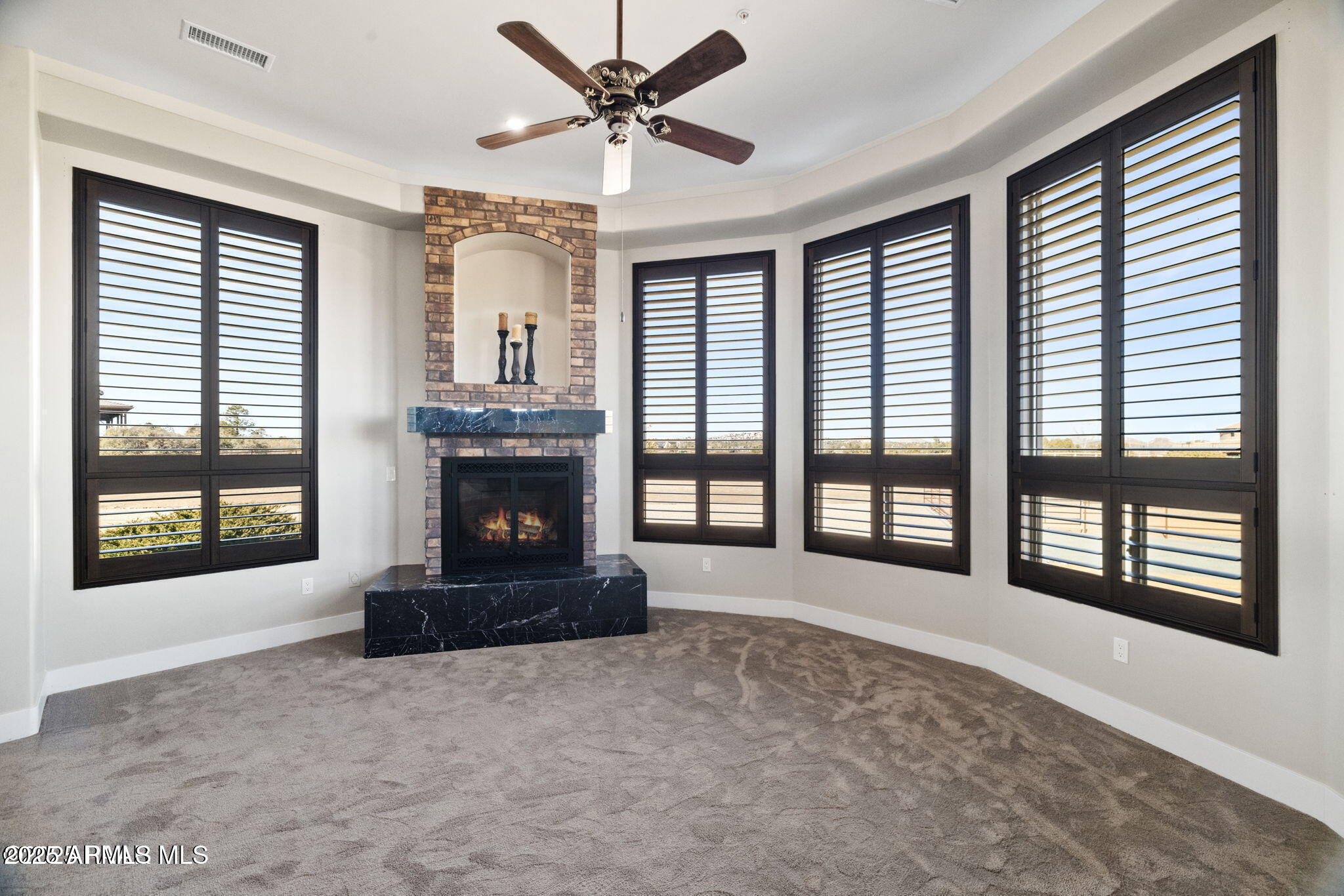4140 Chuckwalla Road Prescott, AZ 86305 - Photo 29 of 77 a living room with a fireplace and a large window