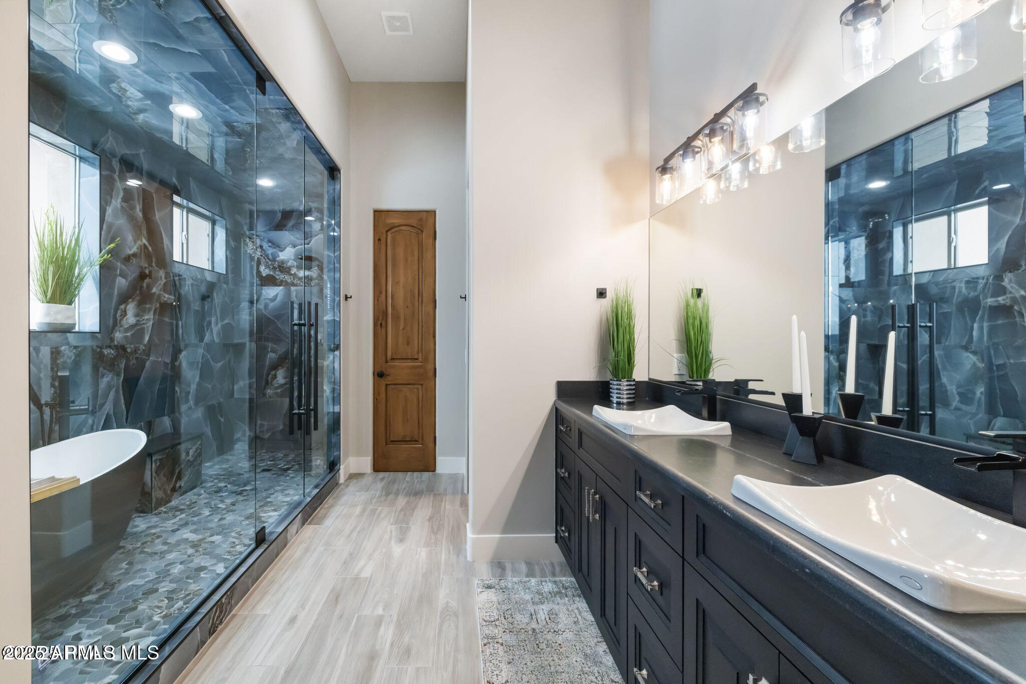 4140 Chuckwalla Road Prescott, AZ 86305 - Photo 31 of 77 a bathroom with a double vanity sink a mirror and shower