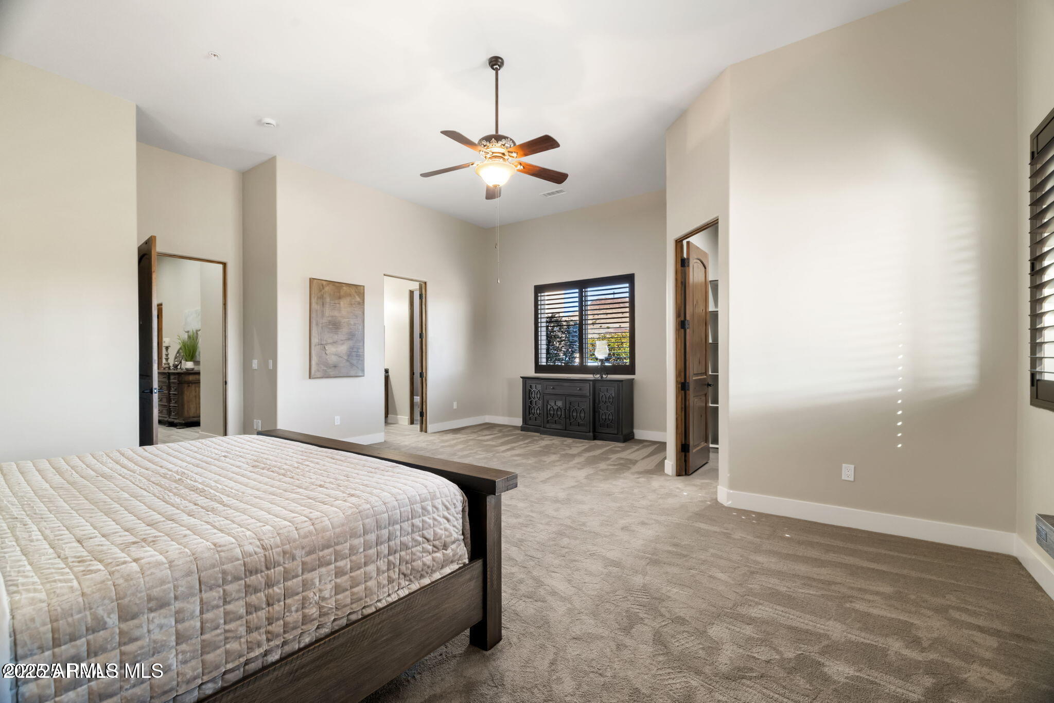 4140 Chuckwalla Road Prescott, AZ 86305 - Photo 46 of 77 a spacious bedroom with a large bed and a chandelier