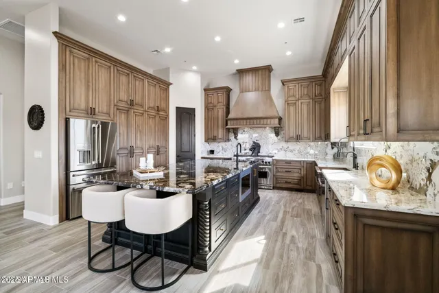 a very nice looking living room with kitchen island furniture a kitchen view and a large window