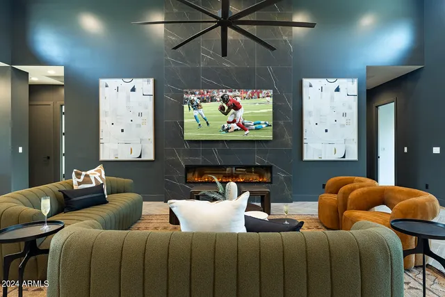 a living room with furniture a fireplace and a flat screen tv