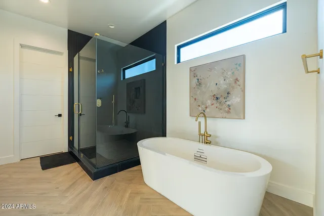 a bedroom with a bed and glass wall