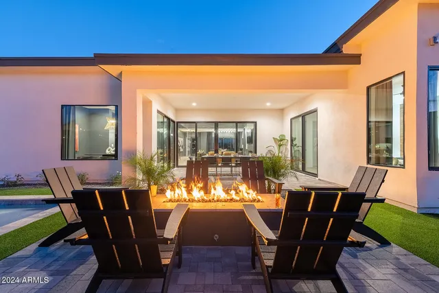 a kitchen with stainless steel appliances wooden cabinets dining table and chairs