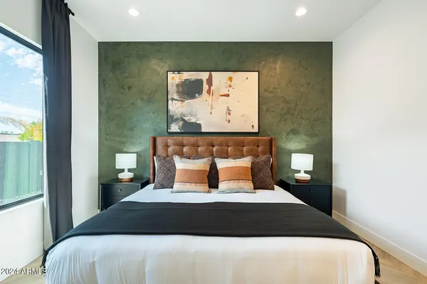 a bedroom with bed and a couch