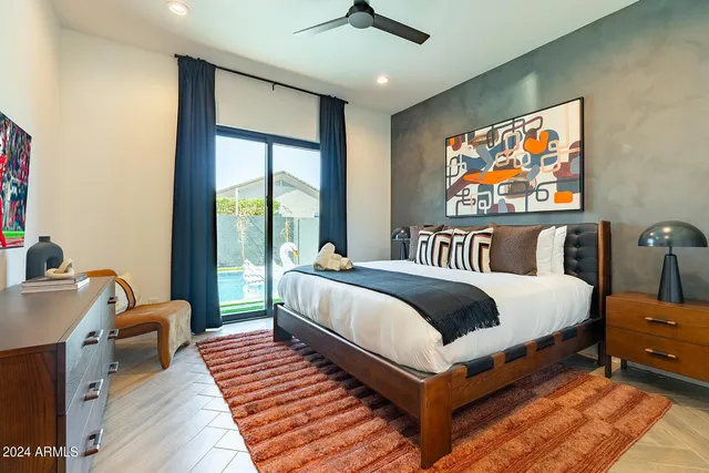 a bedroom with furniture and a large window