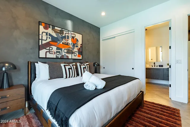 a bedroom with a bed and wooden floor