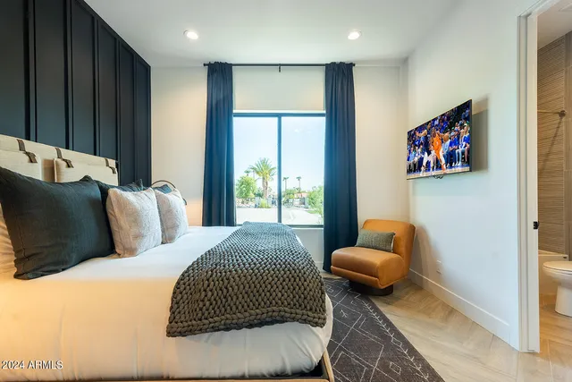 a bedroom with a bed and glass windows