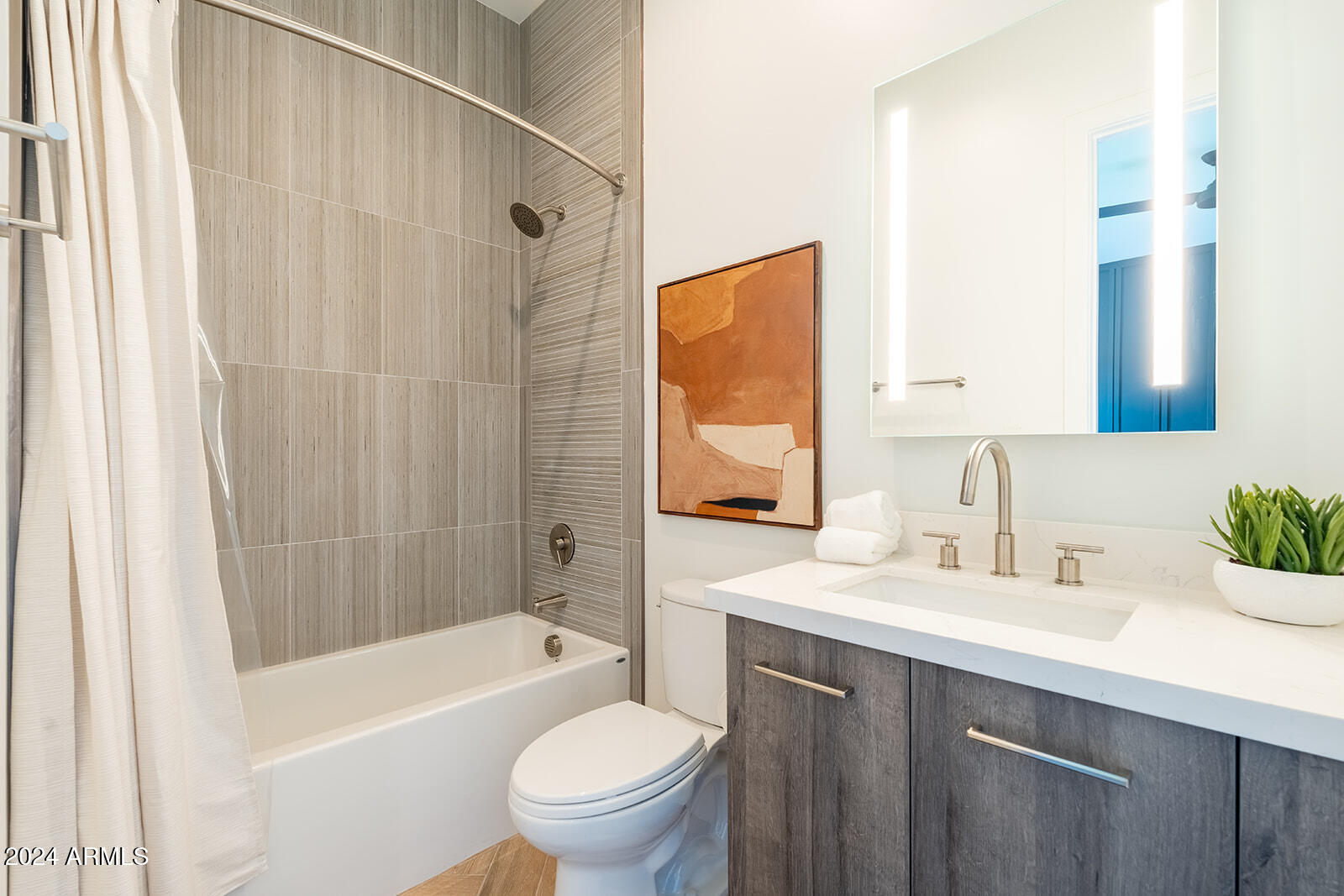 13696 North 88th Place Scottsdale, AZ 85260 - Photo 41 of 60 a bathroom with a sink a toilet a mirror a bathtub and shower