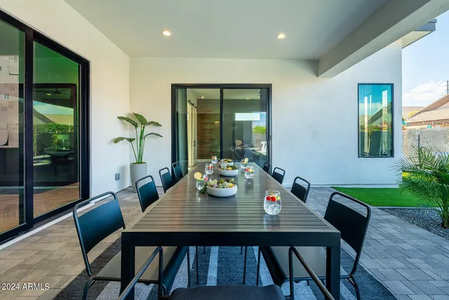 a backyard of a house with outdoor seating