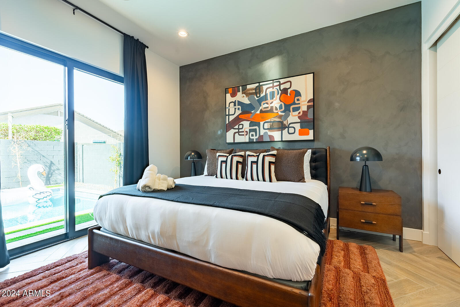 13696 North 88th Place Scottsdale, AZ 85260 - Photo 45 of 60 a bedroom with a bed and glass windows