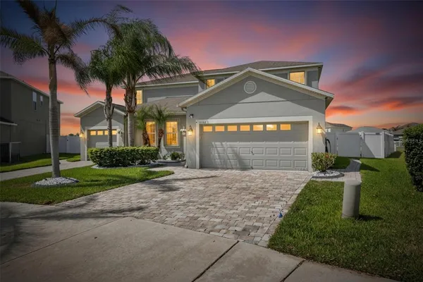 a front view of a house with a yard and garage