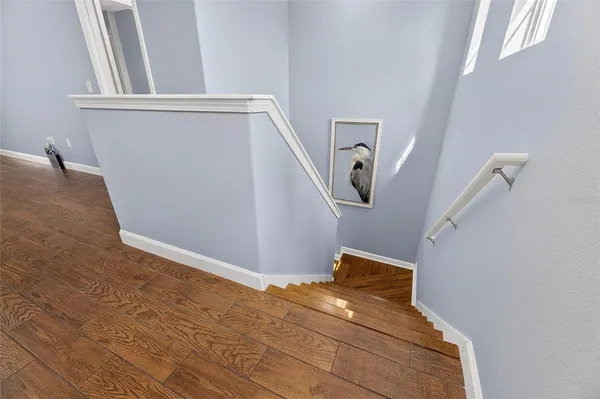 a aerial view of a house with swimming pool and large trees