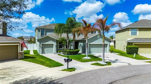 a living room with furniture and a dining table with projector the kitchen