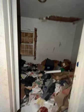 a room with water heater and wooden cabinets