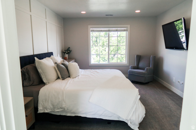 1204 North 3020th Street West Provo, UT 84601 - Photo 26 of 35 Primary bedroom featuring a decorative accent wall, recessed lighting, and a large window