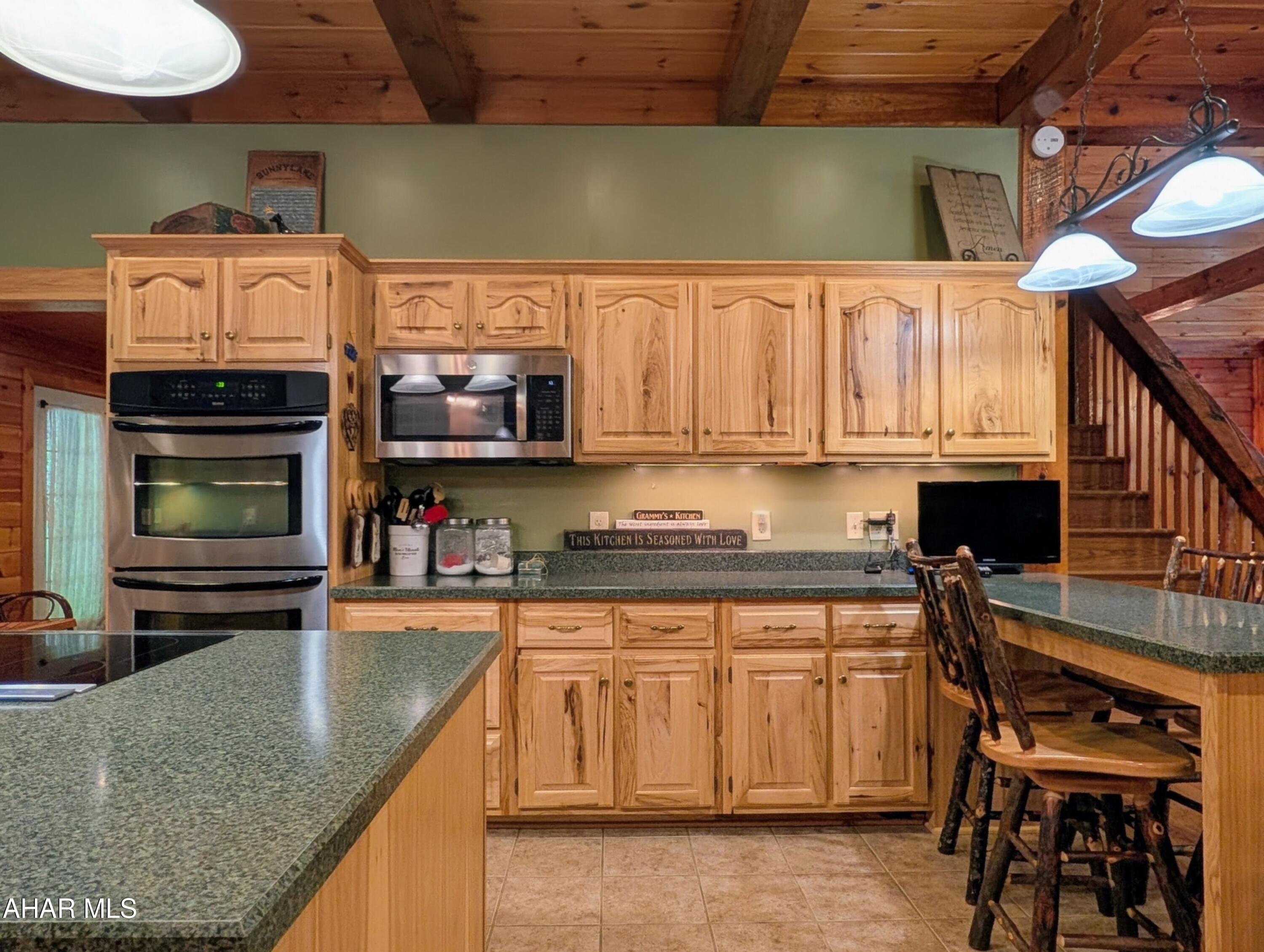 213 Sherman Valley Road Hopewell, PA 16650 - Photo 14 of 104 a kitchen with stainless steel appliances granite countertop a stove a sink and a microwave