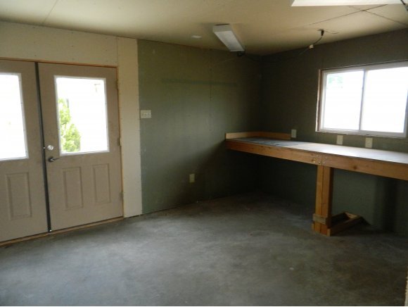 1550 Ranch House Road Paulden, AZ 86334 - Photo 18 of 24 a room with a wooden floor and a window