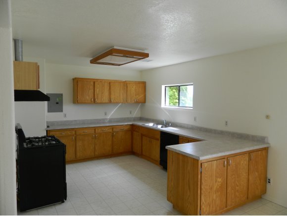 1550 Ranch House Road Paulden, AZ 86334 - Photo 3 of 24 a kitchen with a sink and a stove top oven