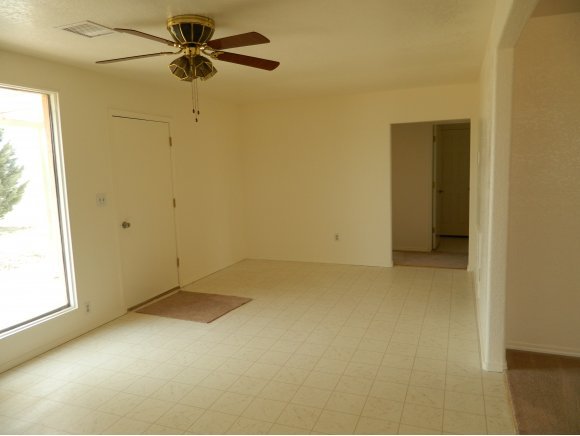 1550 Ranch House Road Paulden, AZ 86334 - Photo 5 of 24 an empty room with a ceiling fan and a window
