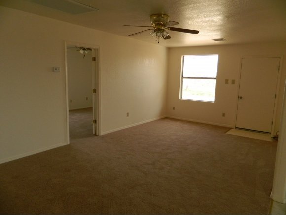 1550 Ranch House Road Paulden, AZ 86334 - Photo 7 of 24 an empty room with windows and fan