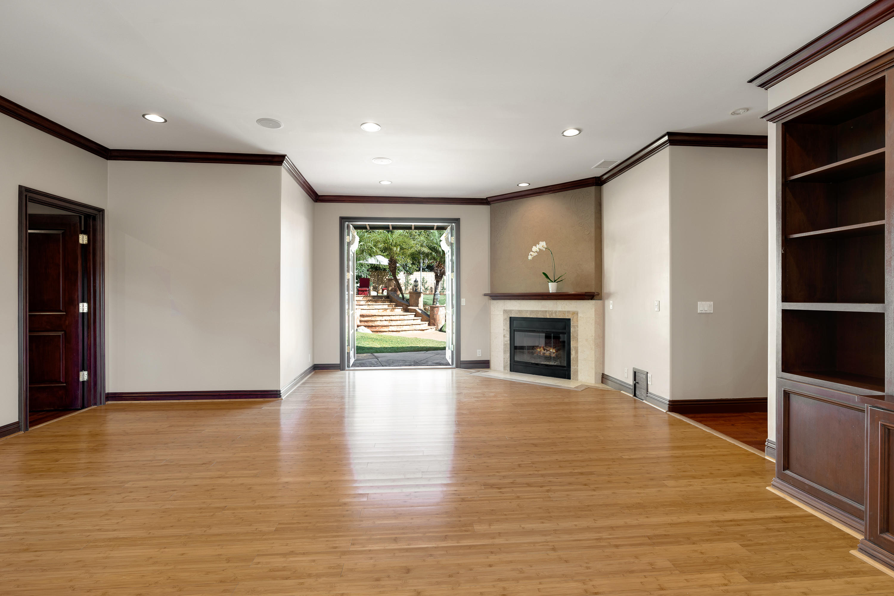 825 Chehalem Road La Canada Flintridge, CA 91011 - Photo 20 of 24 a view of an empty room with wooden floor and a fireplace