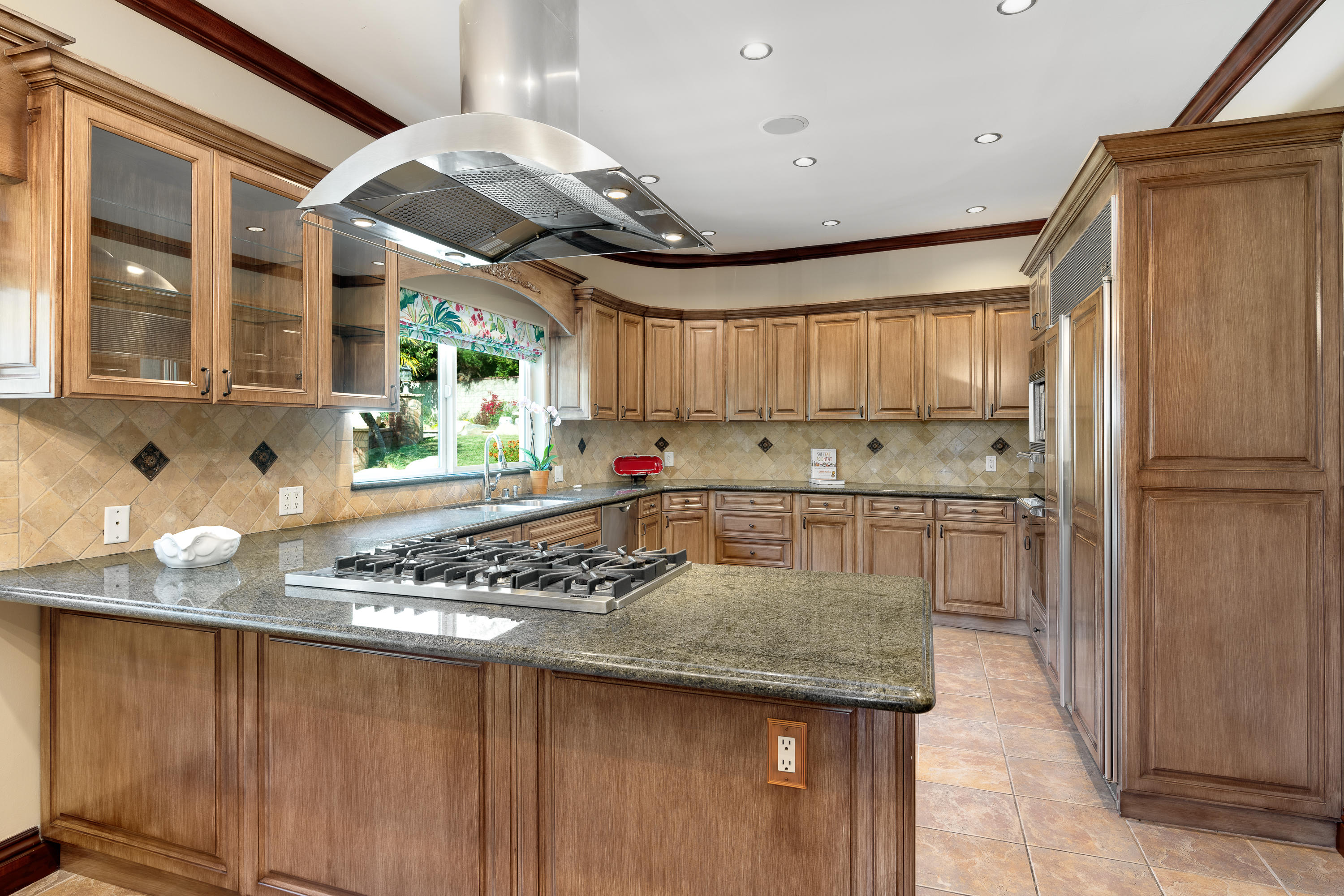 825 Chehalem Road La Canada Flintridge, CA 91011 - Photo 8 of 24 a kitchen with stainless steel appliances granite countertop a sink window and cabinets