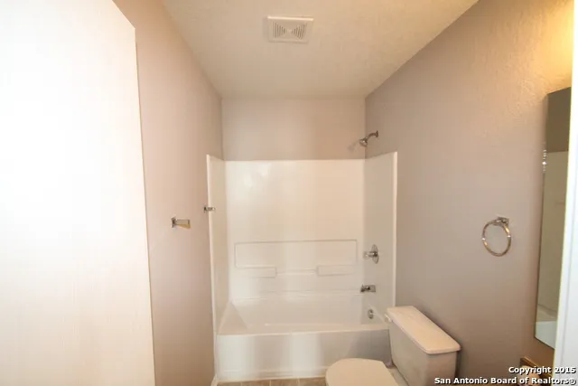 a bathroom with a shower and toilet