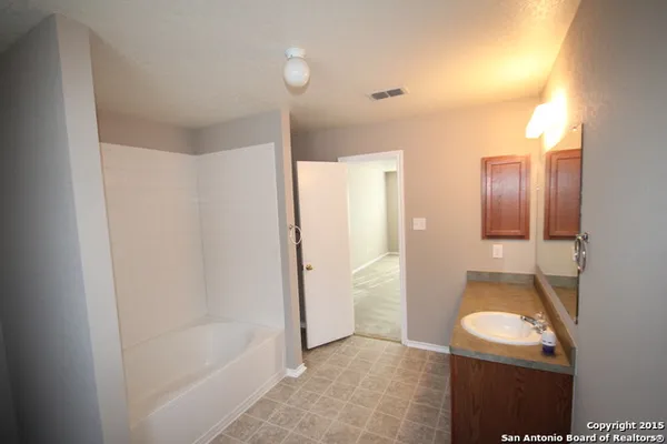 a bathroom with a bathtub and shower