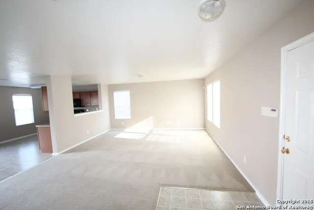 a view of a big room with windows and cabinet