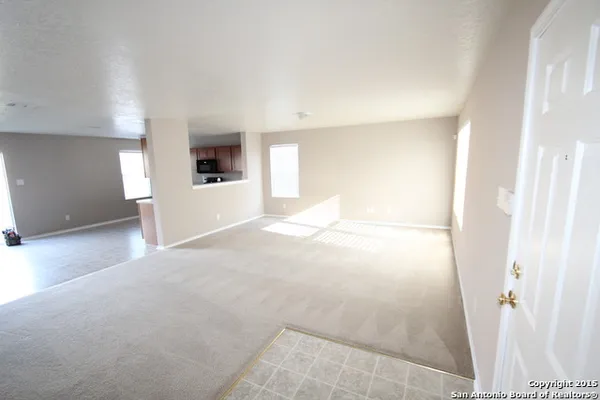 a view of a big room with wooden floor and cabinet